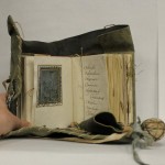 Small parchment book with leater girdle book binding