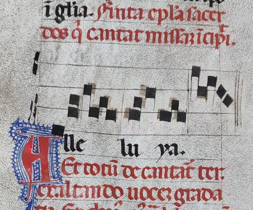 Close up of medieval music where notes run off page