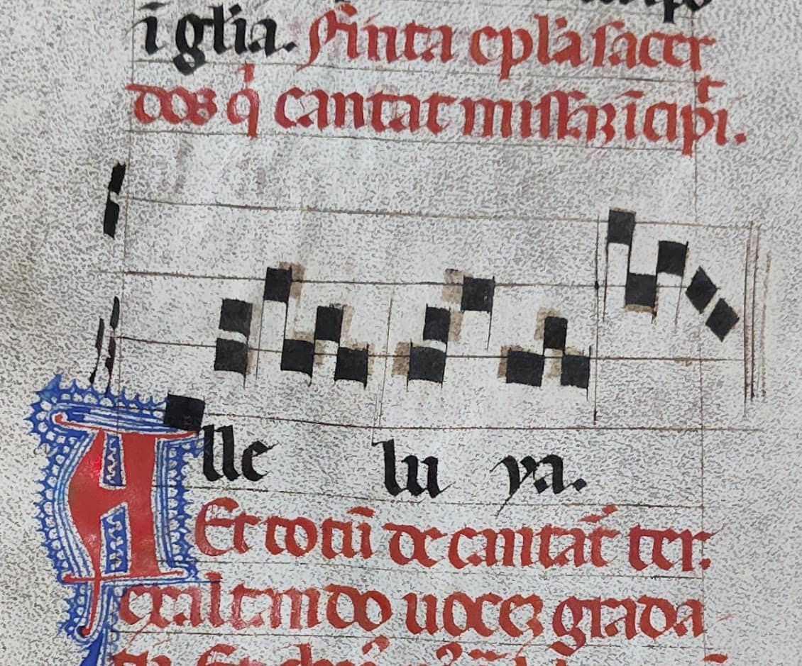 Close up of medieval music where notes run off page