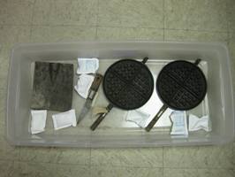 plastic tub with metal objects and dessicants