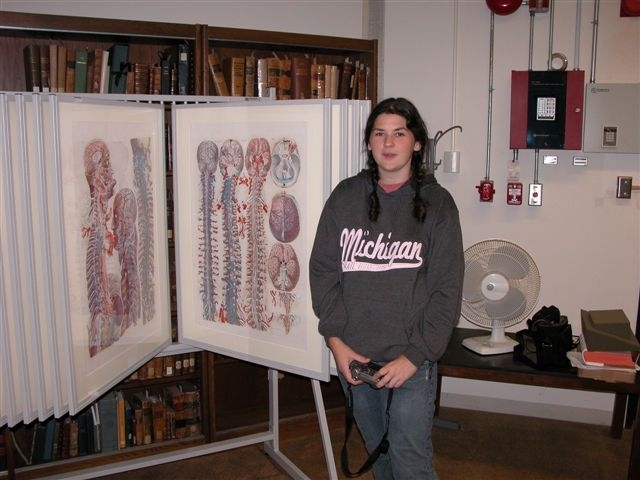 Shown is Caitlin Moore who cut mats and assembled the forty display frames.