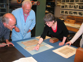 Below, left: Larry Yerkes and Gary Frost study an Armenian Manuscript with Sylvie. 