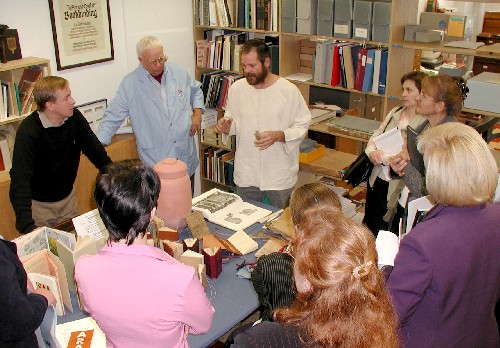 Russian visitors and Gary Frost (in blue) listen to Jim Croft (center) explain how the Russian import of flax played an important role in bookbinding history.