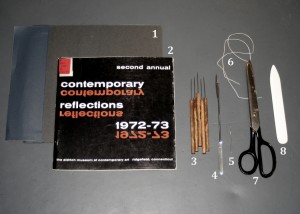 Tools and materials needed for pamphlet binding.