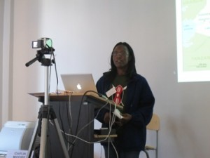 Student standing in front of a cameragiving power point presentation