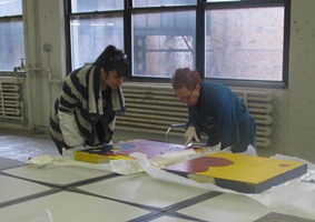 Kraft and artist examine a painting