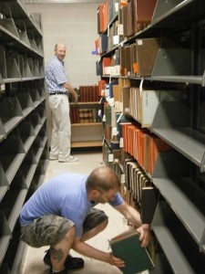 Library Staff Volunteers reshelve items from the basement on the 4th floor.