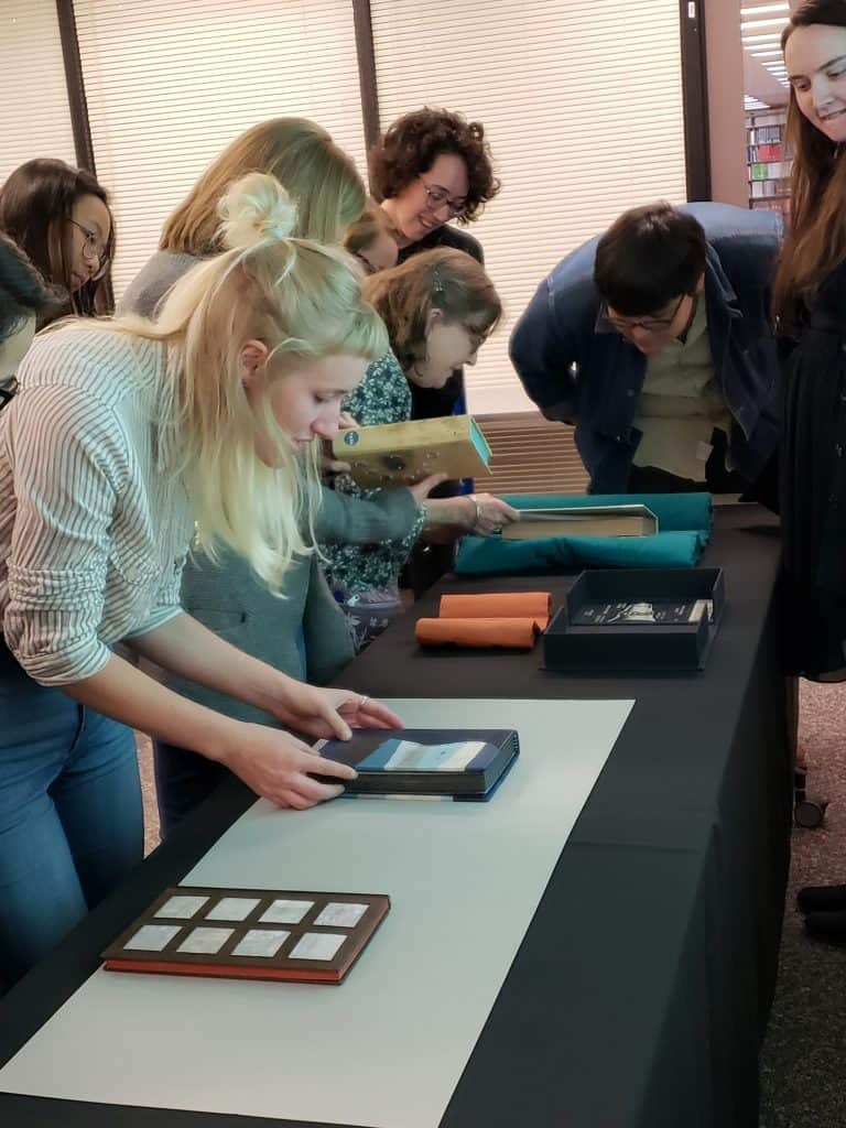 students looking at books