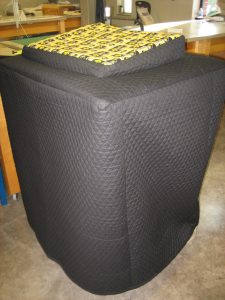A black, quilted fabric cover for the commencement podium.