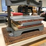 Bound book is drying in a press