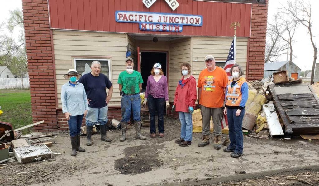 Seven IMALERT members pause for a group photo in front of the Pacific Junction Railroad Museum.