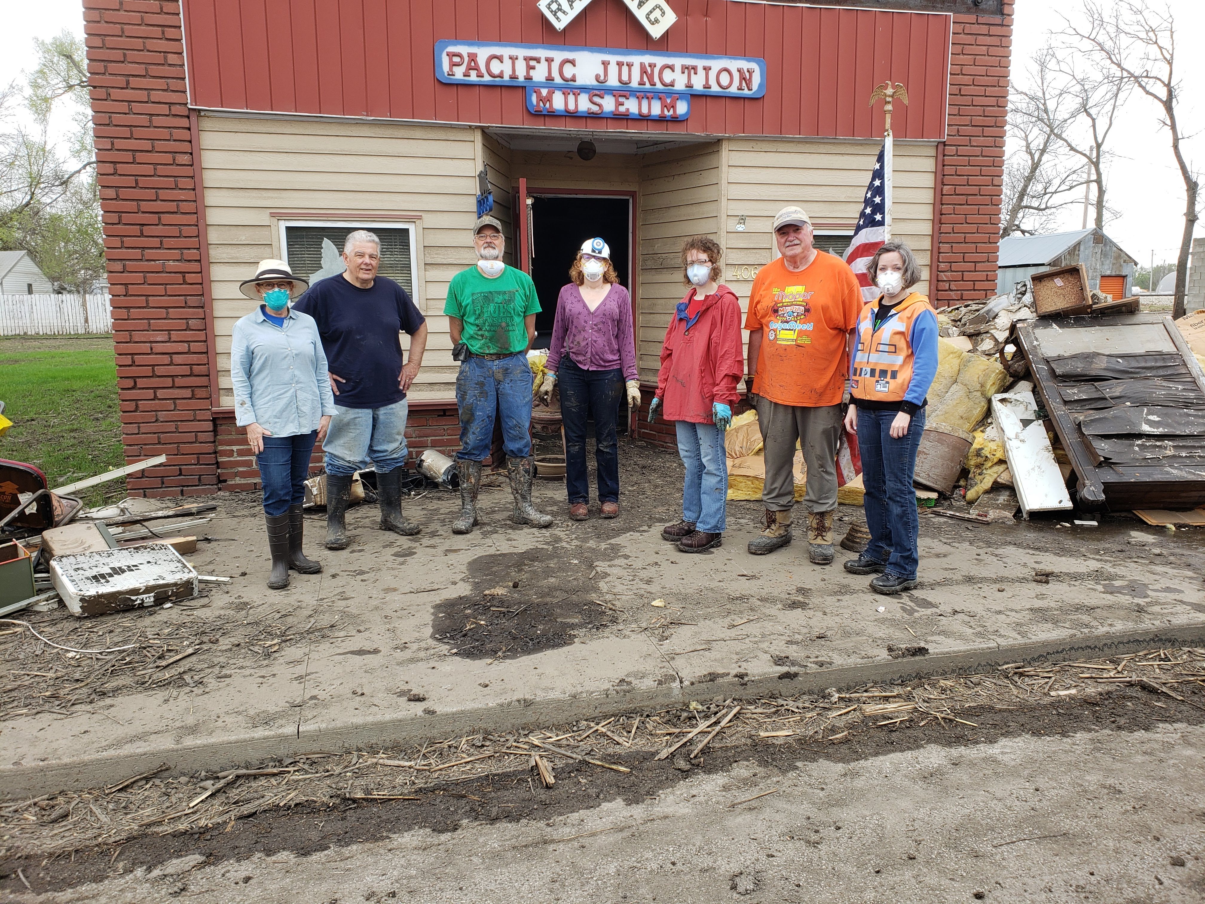 Seven IMALERT members pause for a group photo in front of the Pacific Junction Railroad Museum.