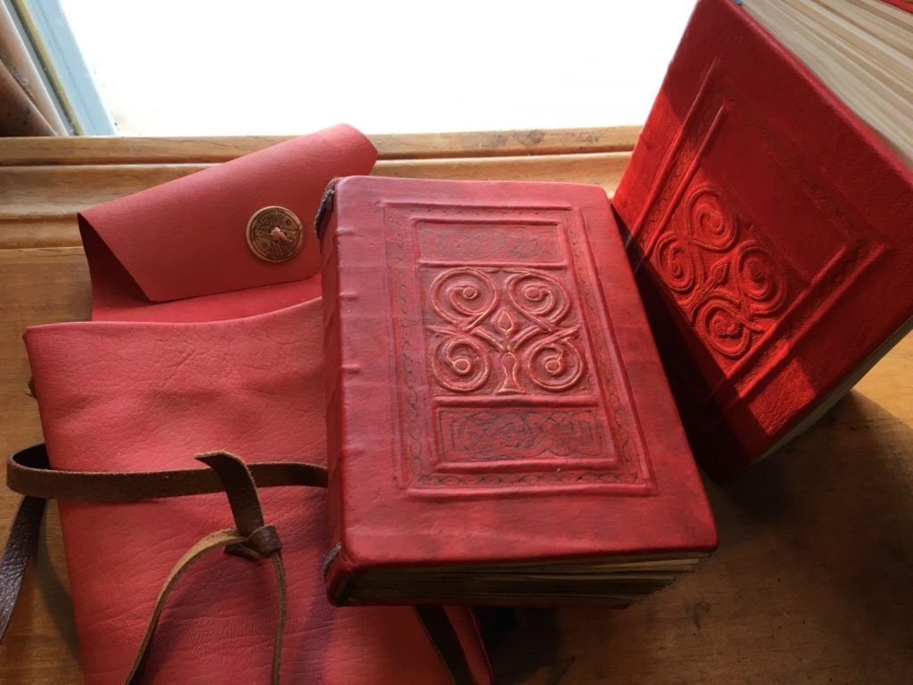 book bound in red leather with molded decoration on cover