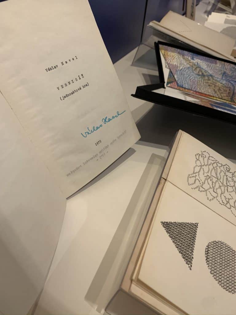 Two books are open inside a gallery case. One is signed by Vaclav Havel.