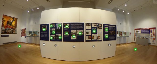 A panoramic view of part of the Main Library Gallery exhibit shows several text panels with clickable icons.