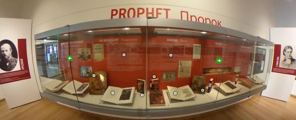 An exhibit case is filled with books and text about the objects on display.