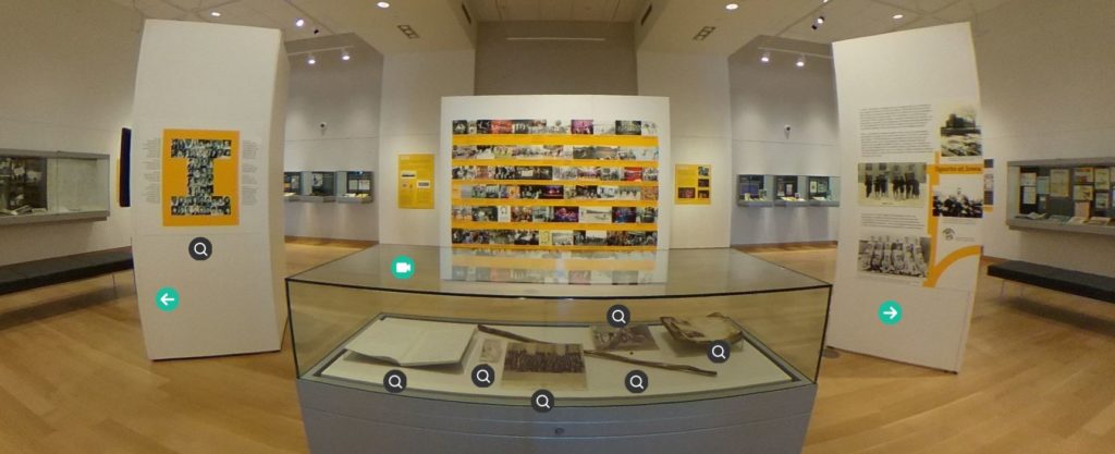 A view of the Main Library Gallery. Icons on items in the exhibit note that more information is available.