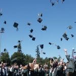graduation caps flying in air