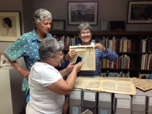 Barb Yates, Francie Hornstein, and Dale McCormick looking at Ain't I a Woman, published by the Women's Liberation Front in Iowa City in the early 1970s. 