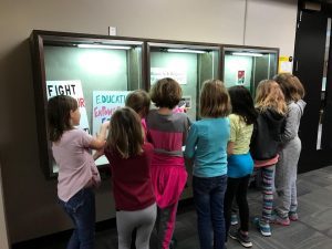 The girls examine our current exhibit "History as it Happens: Women's March 2017