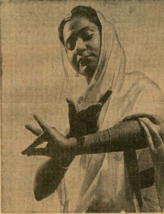 Sepia toned picture of woman in sari dancing