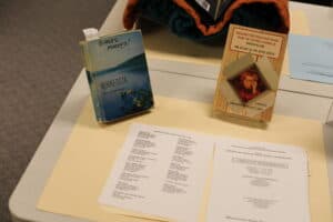 color photo of a table with a copy of Marion's biography and a Minnesota history textbook with a note on the cover reading Biases Marked