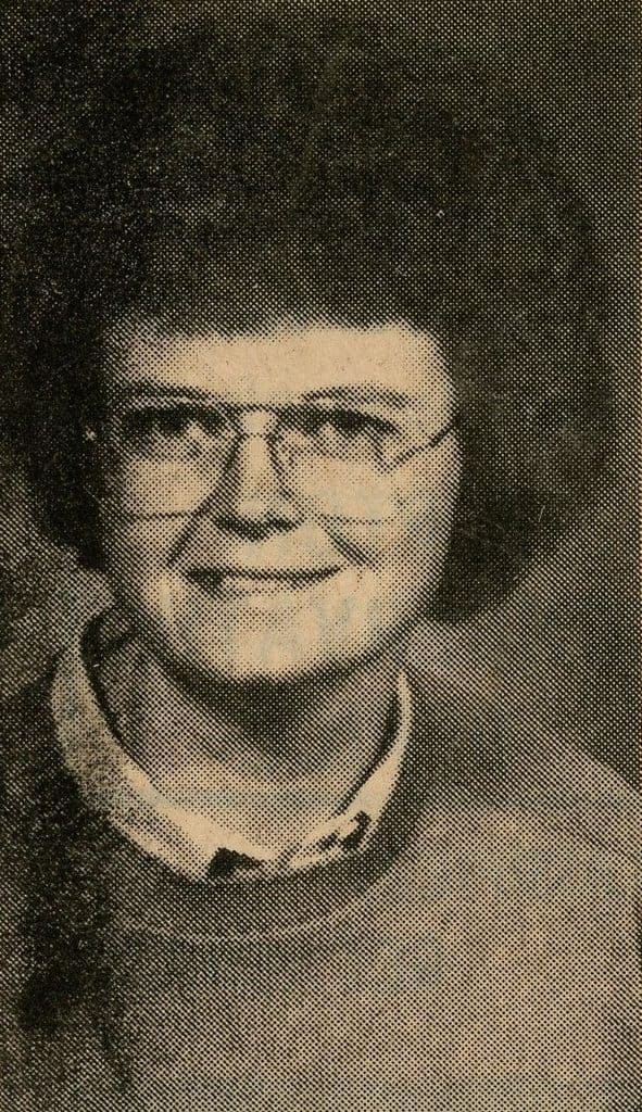 Newspaper portrait of a short-haired woman with glasses and a sweater
