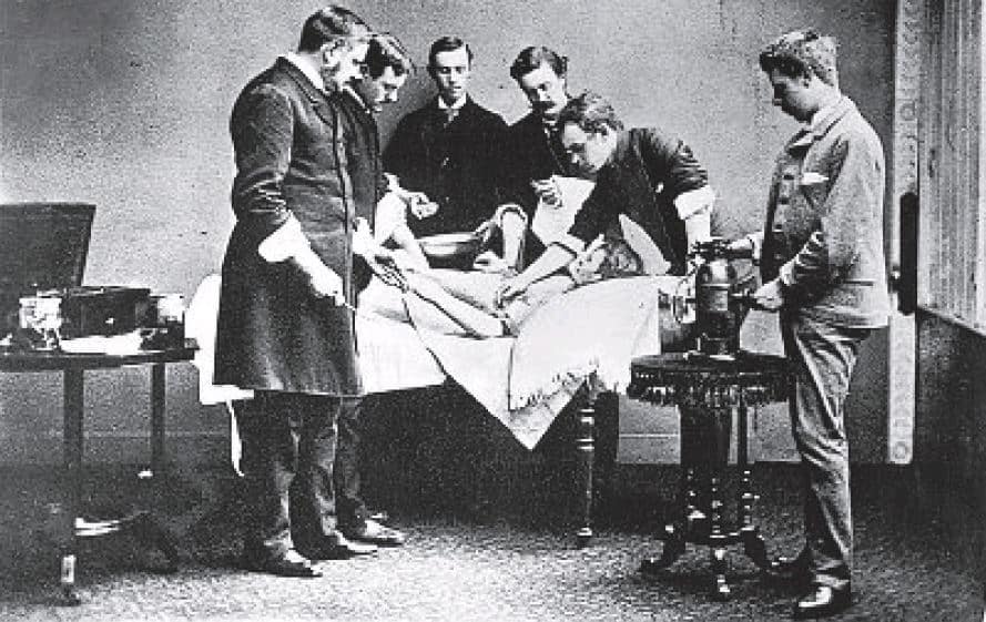 picture of 6 men around a surgical patient