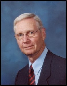 image of Dr. Robert Rakel, white man, glasses, suit and tie