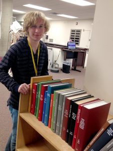 image of Jake Edwards, white male with cart of books
