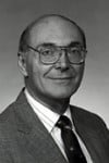 image of Dr. Richard Caplan, white man, glasses, suit