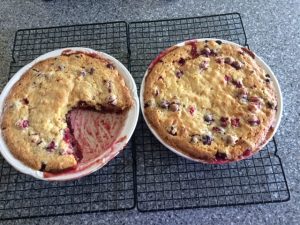 2 cranberries pies on cooling rack with one big piece eaten