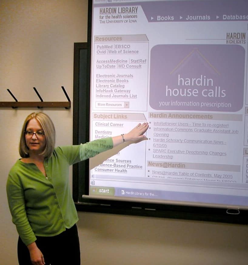 woman displaying website to class
