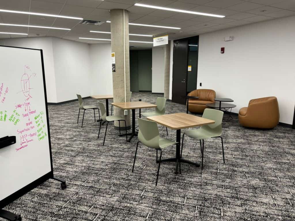 library study space with tables and chairs and whiteboard
photo by Lisa Carrasco