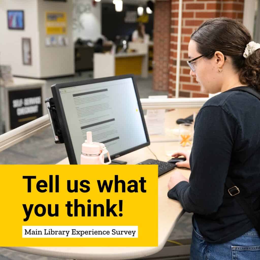 UI student takes a survey on a computer at the Main Library
