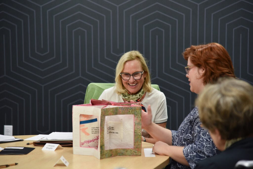 Christie Krugler recieves an artist book for Special Collections