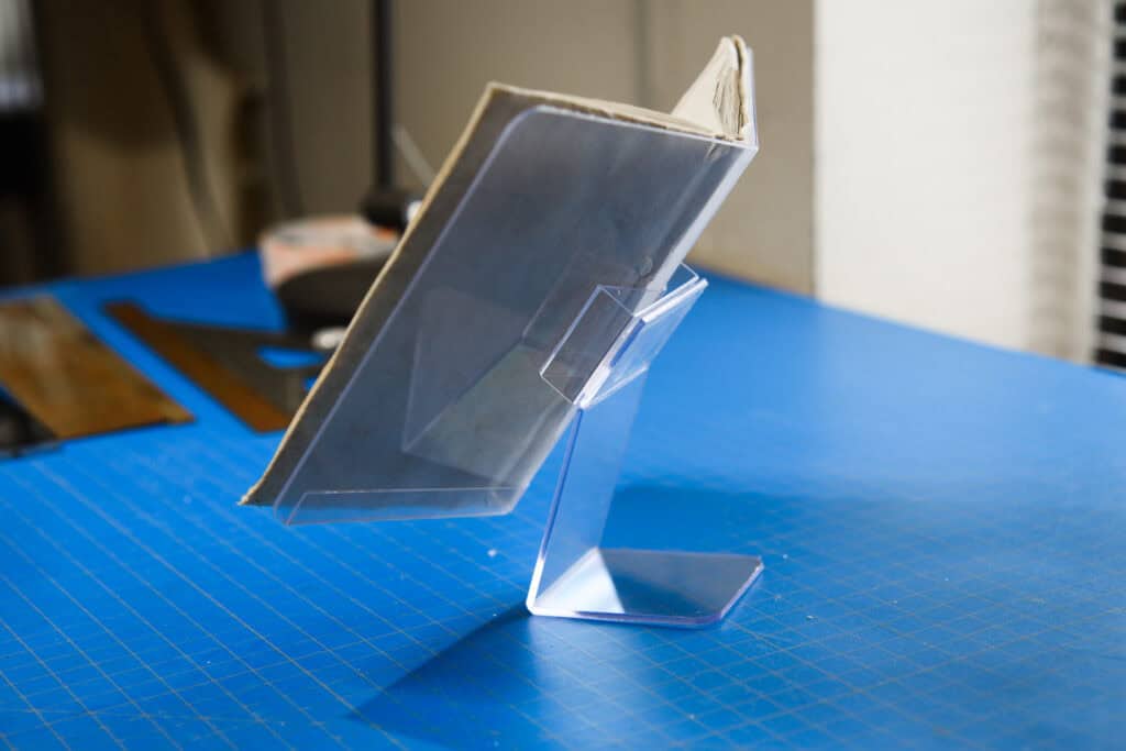 A book rests on a custom-made mount