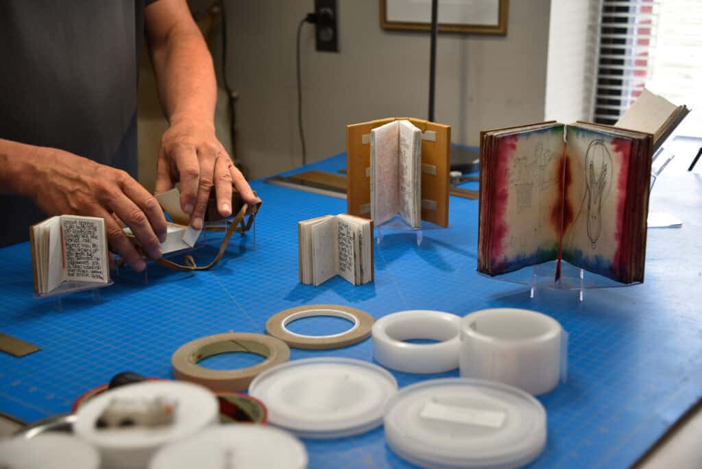 Bill prepares mounts for small books
