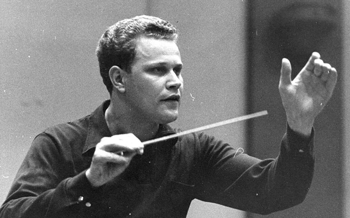 A black-and-white photo of James Dixon conducting 