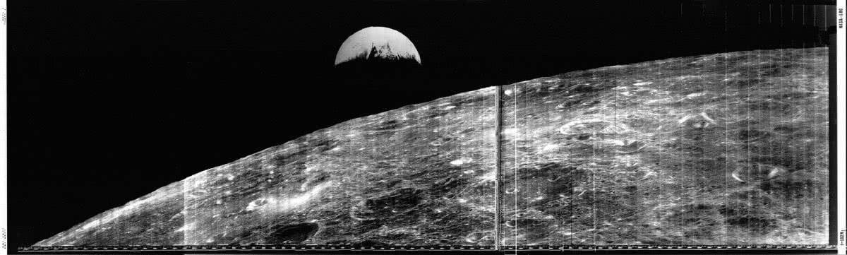 Lunar Orbiter 1 new of the Moon and crescent Earth.