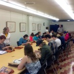 Students looking at materials in a Special Collections class