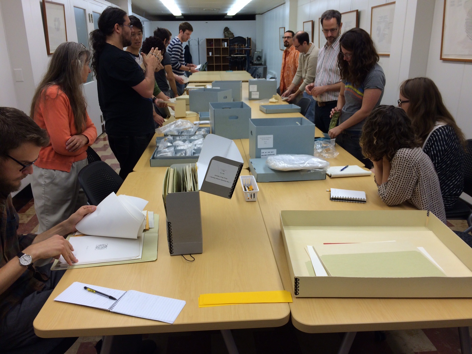 an image of students looking at Fluxus materials in the Special Collections classroom