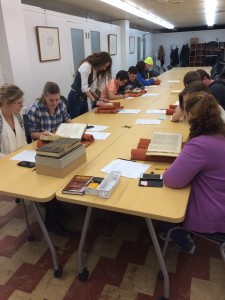 Image of a class of students examining books