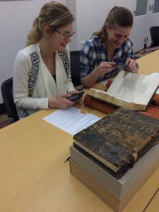 Image of two students examining a book