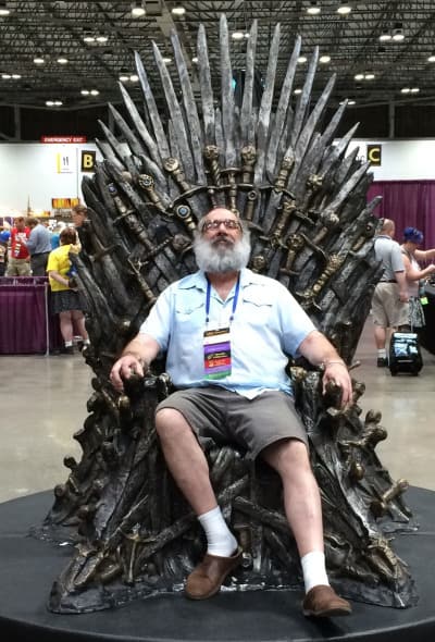 Peter Balestrieri sitting on the Iron Throne at World Con