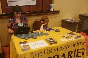 A woman and a girl sitting at a UI Libraries table