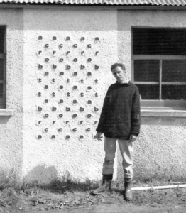 Ian Finlay in front of wall with letters on it