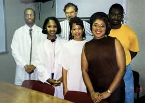 Kerber standing with 5 Black Students in classroom