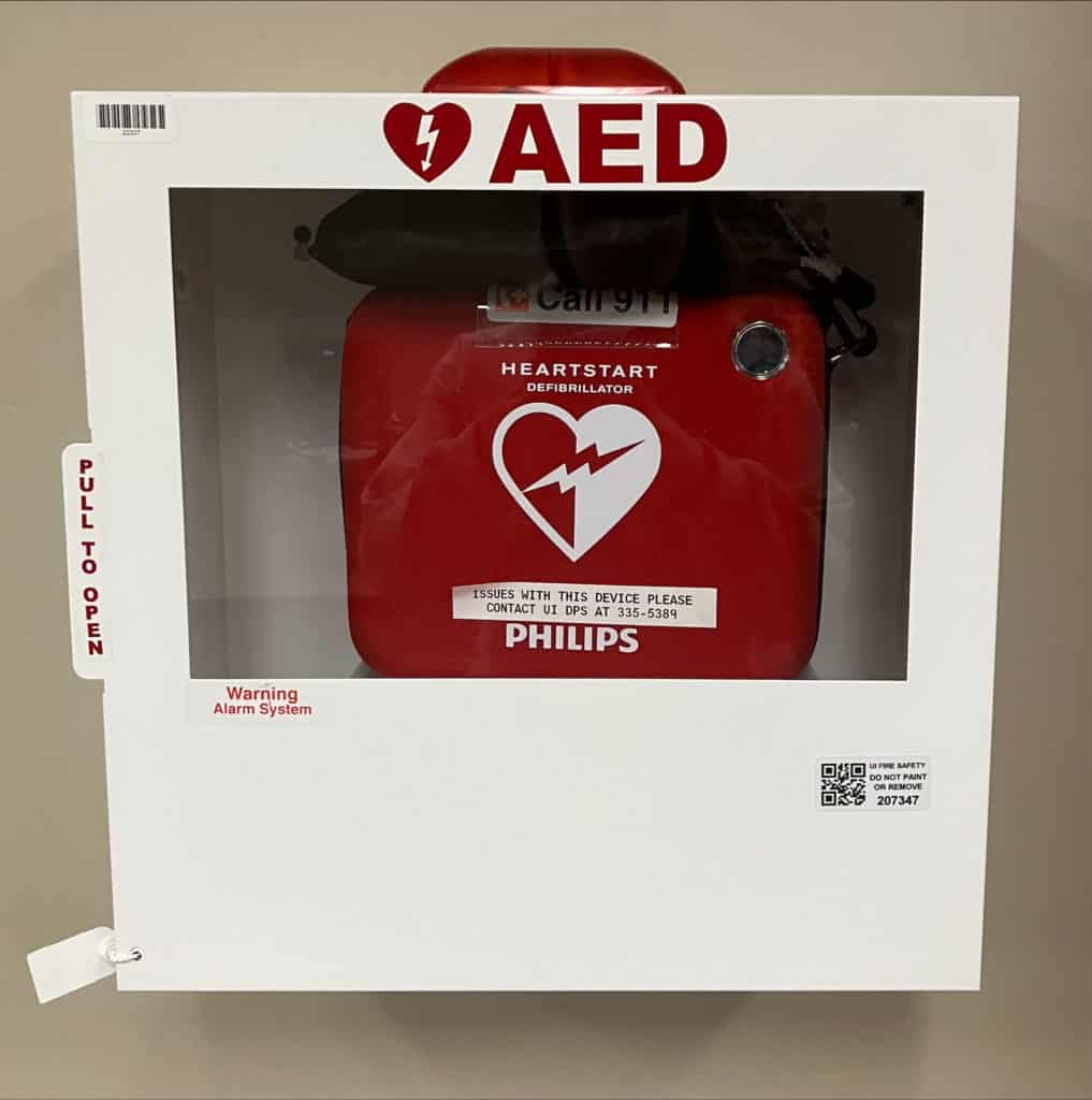 White AED metal box with red defibrillator