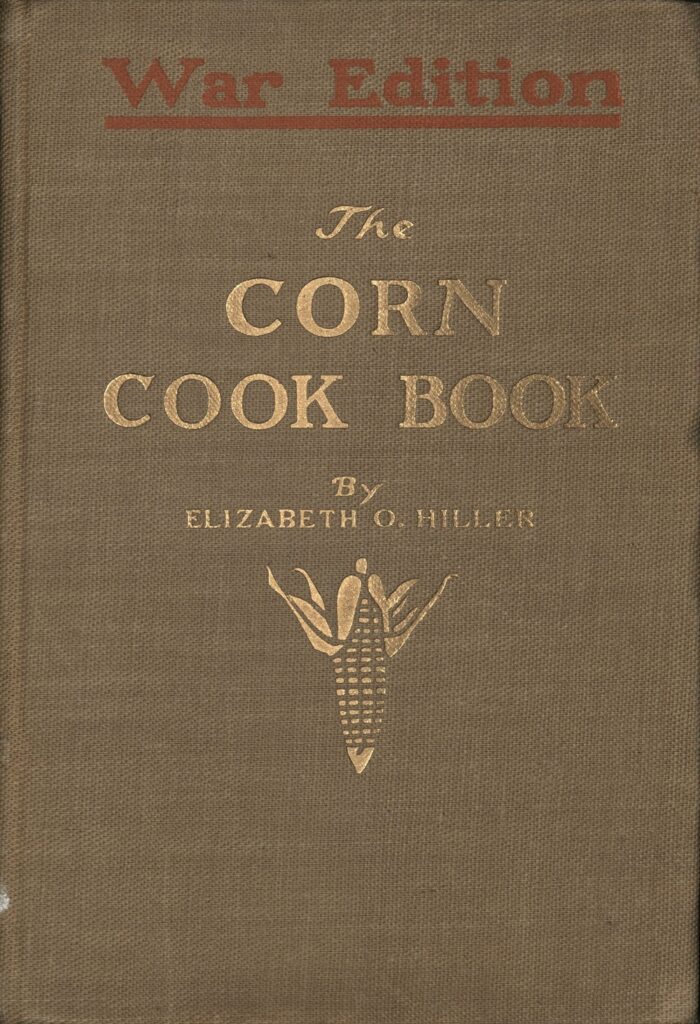 Cloth book cover that features the words Corn Cook Book and a picture of corn in gilt